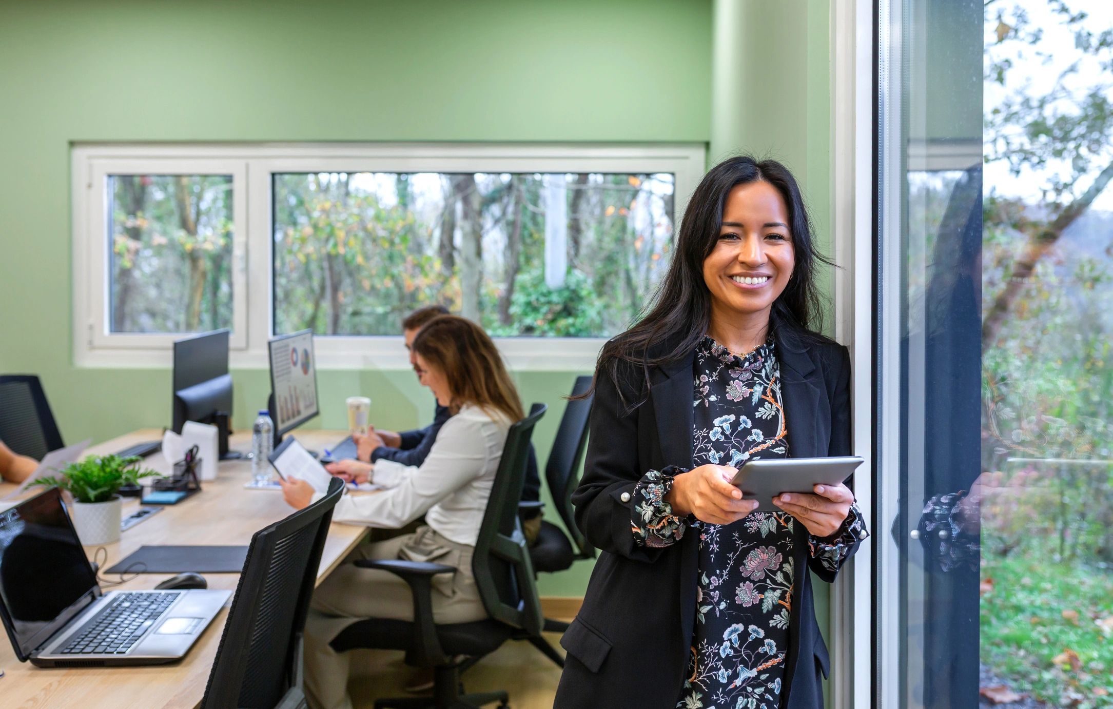 Business manager holding a tablet in a modern workplace